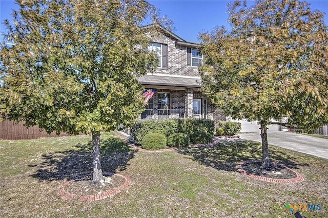 view of property hidden behind natural elements with a front lawn