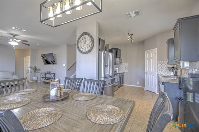 dining space featuring stairs, ceiling fan, light tile patterned floors, and visible vents