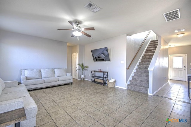 tiled living room with ceiling fan