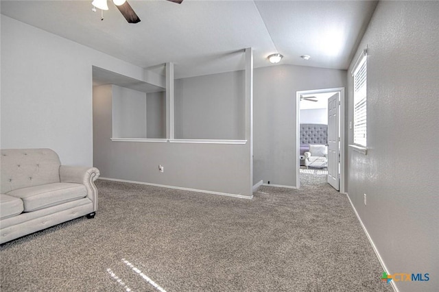 interior space with ceiling fan, vaulted ceiling, and carpet