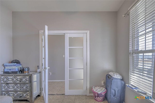 interior space featuring a healthy amount of sunlight and light tile patterned flooring