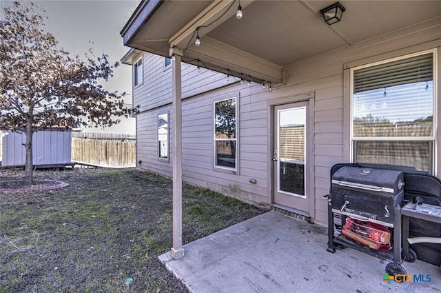 view of exterior entry with a patio