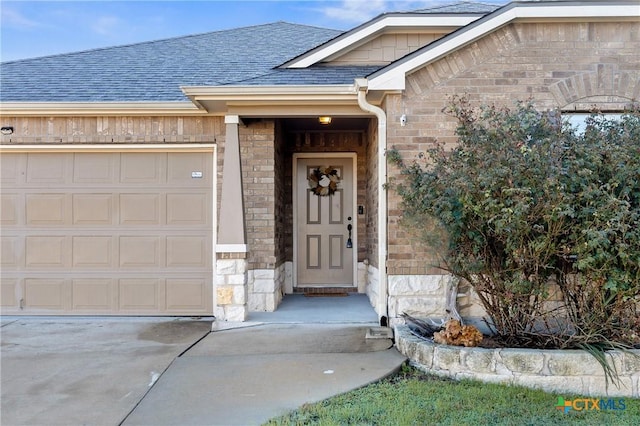 view of exterior entry featuring a garage