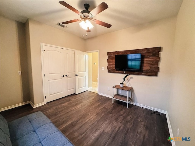 bedroom featuring a closet, dark hardwood / wood-style floors, and ceiling fan