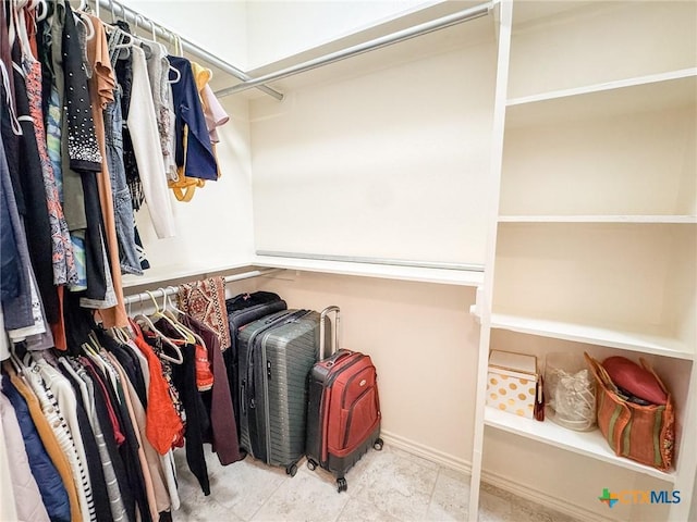 walk in closet featuring light tile patterned floors