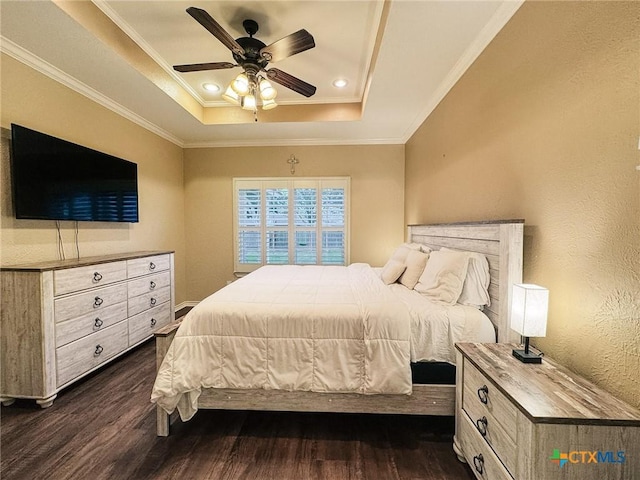 bedroom with a raised ceiling, ornamental molding, dark hardwood / wood-style floors, and ceiling fan