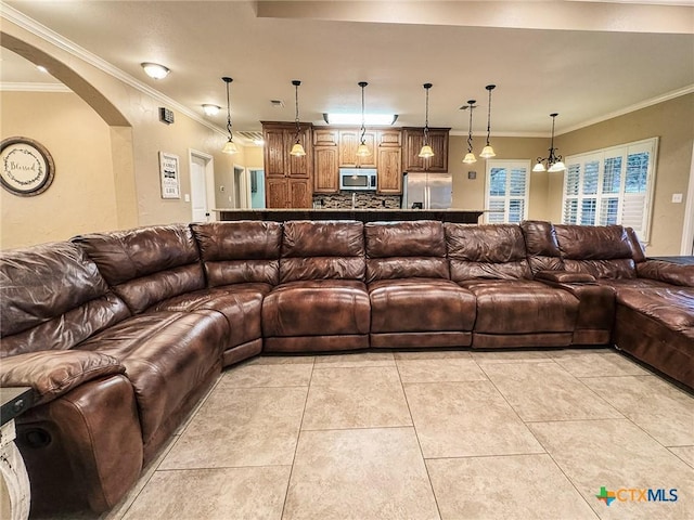 living room with crown molding and light tile patterned flooring