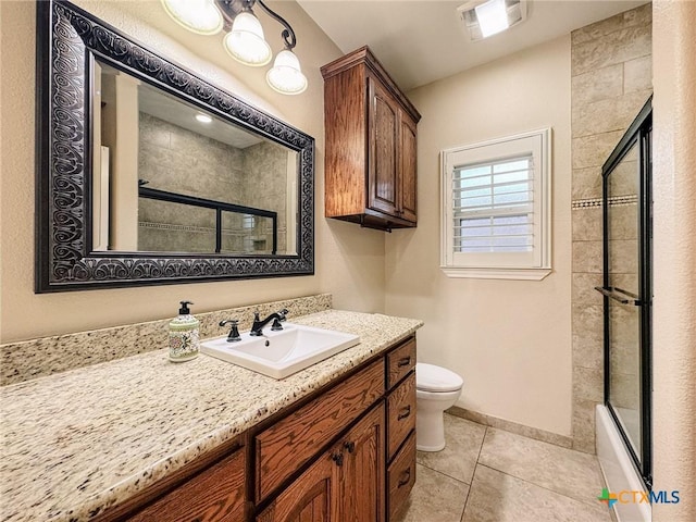 full bathroom featuring tile patterned flooring, bath / shower combo with glass door, vanity, and toilet