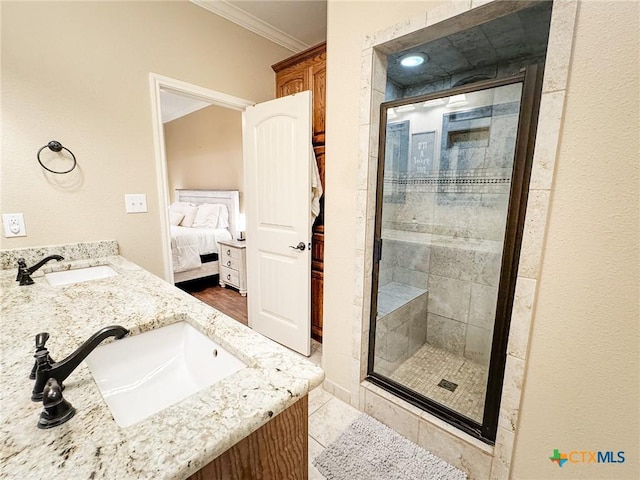 bathroom with vanity, crown molding, tile patterned floors, and walk in shower