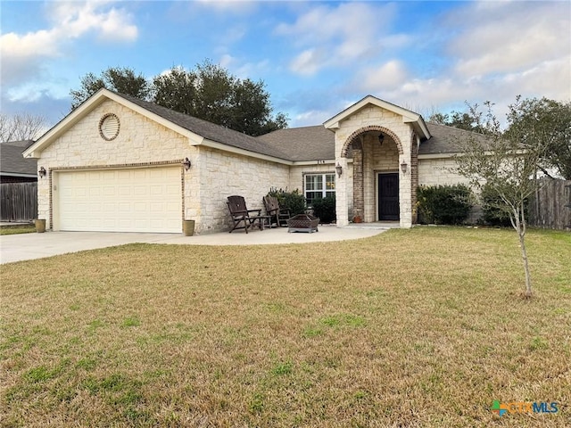 single story home featuring an outdoor fire pit, a front lawn, and a garage