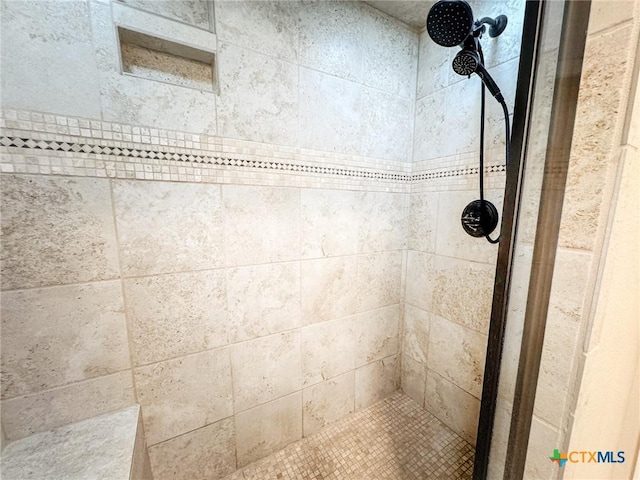 bathroom with tiled shower