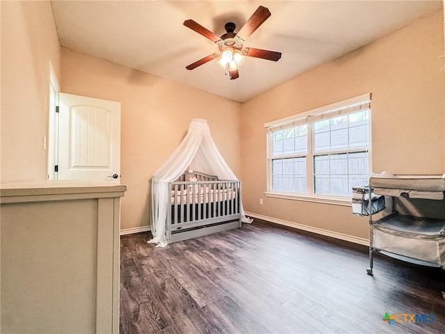 bedroom featuring dark hardwood / wood-style floors and ceiling fan