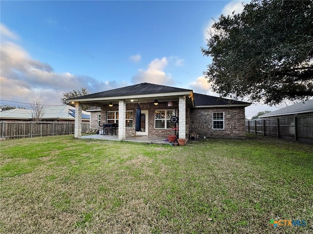 back of house featuring ceiling fan, a yard, and a patio area