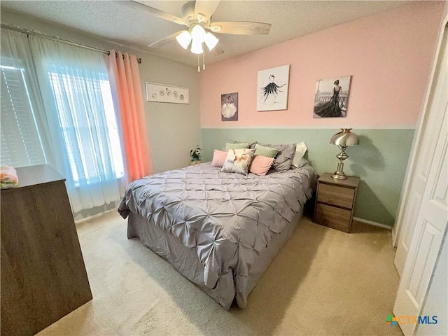 403 Suzie St, Killeen, TX 76542 - carpeted bedroom with multiple windows, a ceiling fan, and a textured ceiling