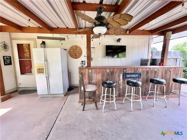 403 Suzie St, Killeen, TX 76542 - indoor dry bar with white refrigerator with ice dispenser, beamed ceiling, concrete flooring, ceiling fan, and wood walls