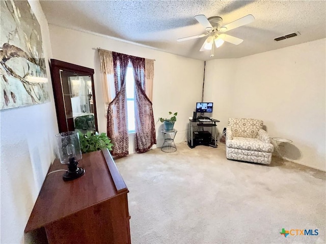 403 Suzie St, Killeen, TX 76542 - living area featuring a textured ceiling, a ceiling fan, and carpet