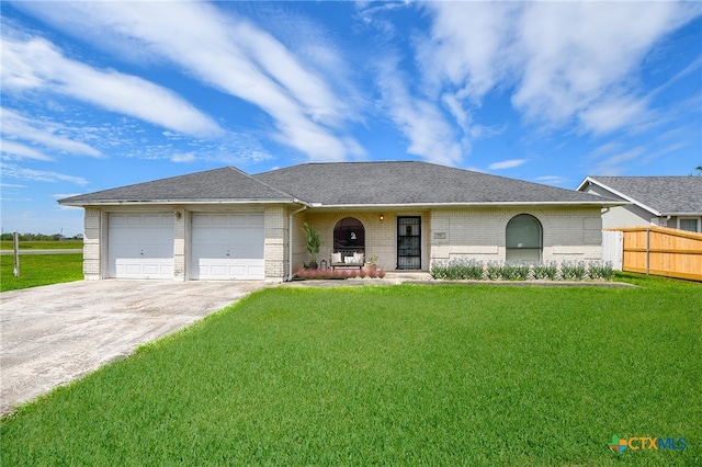 ranch-style house featuring a garage and a front lawn