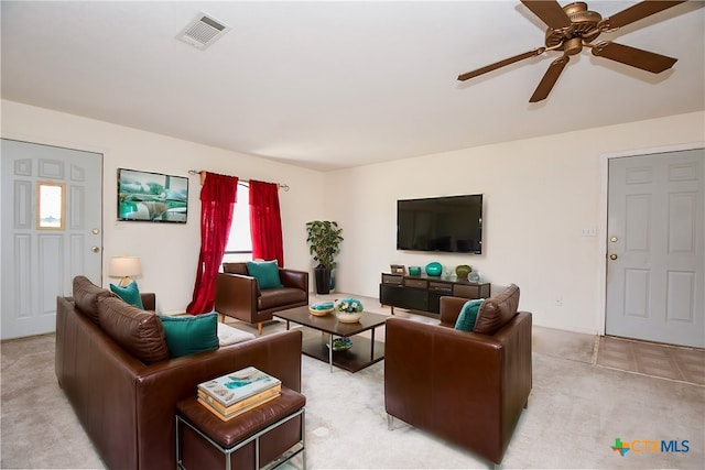 carpeted living room featuring ceiling fan