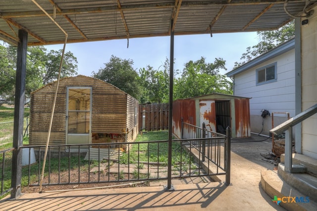 view of patio with a storage shed