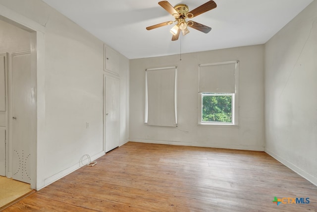 spare room with light wood-type flooring and ceiling fan