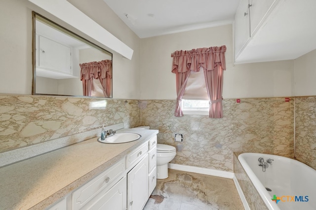 bathroom featuring toilet, vanity, and a bathtub