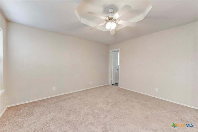 spare room with light colored carpet and ceiling fan