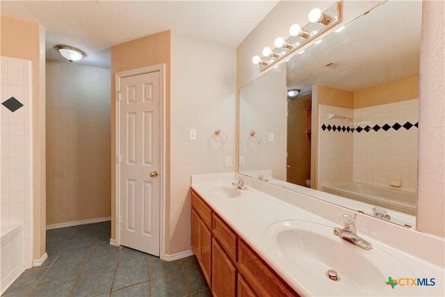 bathroom with tile patterned flooring, vanity, and shower / bathing tub combination