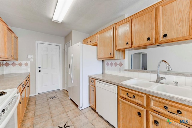 kitchen with sink, light brown cabinets, backsplash, white appliances, and light tile patterned floors