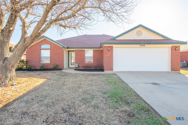 single story home featuring central AC unit, a garage, and a front lawn