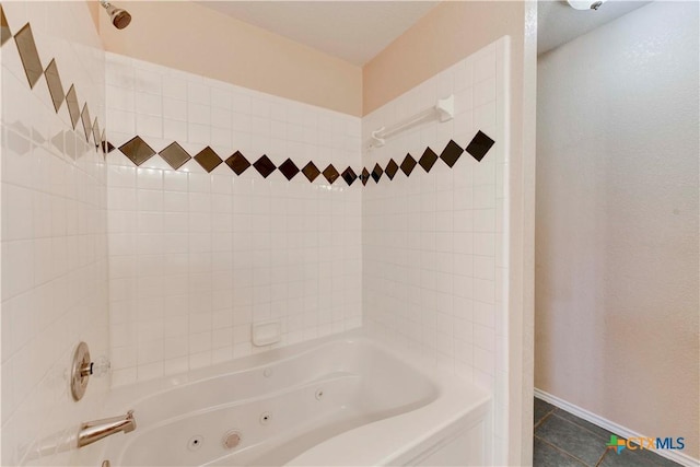 bathroom with tile patterned flooring and tiled shower / bath