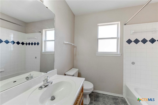 full bathroom featuring tile patterned floors, vanity, toilet, and tiled shower / bath combo