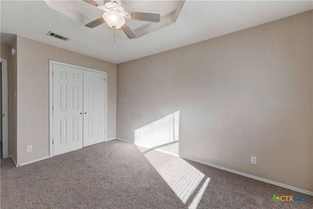 unfurnished bedroom featuring carpet flooring, a closet, and ceiling fan