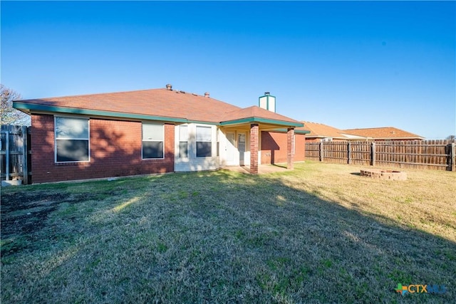 rear view of house featuring a lawn