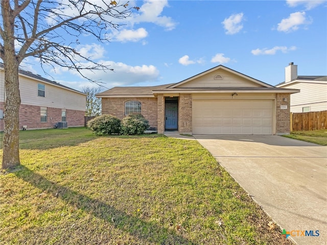 ranch-style house featuring a garage, central AC unit, and a front yard