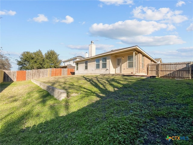 back of property featuring a lawn