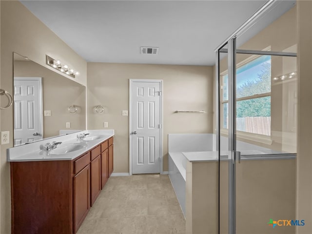 bathroom with shower with separate bathtub, vanity, and tile patterned floors