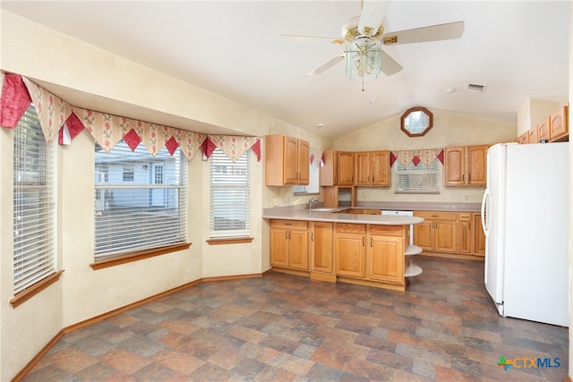 kitchen with sink, kitchen peninsula, ceiling fan, lofted ceiling, and white fridge