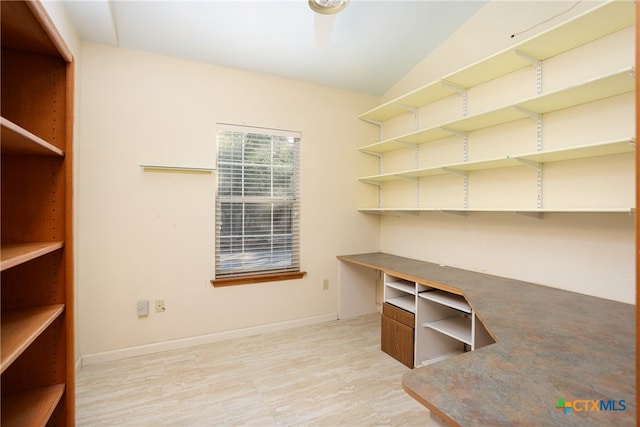 unfurnished office featuring lofted ceiling and wood-type flooring