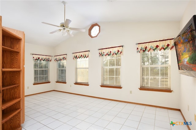 tiled spare room featuring vaulted ceiling and ceiling fan