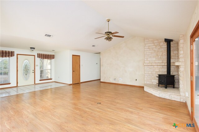 unfurnished living room featuring ceiling fan, light hardwood / wood-style flooring, and vaulted ceiling