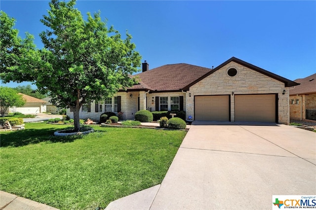 view of front of property featuring a garage and a front lawn