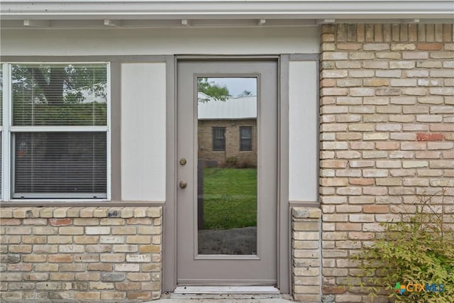 entrance to property featuring stone siding