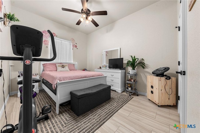 bedroom featuring baseboards and ceiling fan