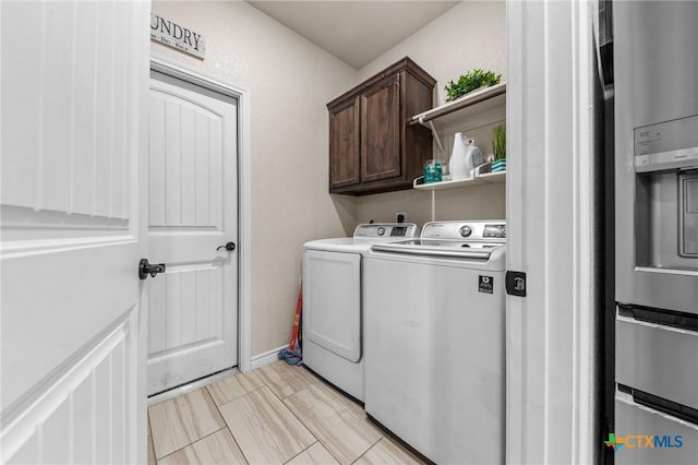 washroom with separate washer and dryer and cabinet space