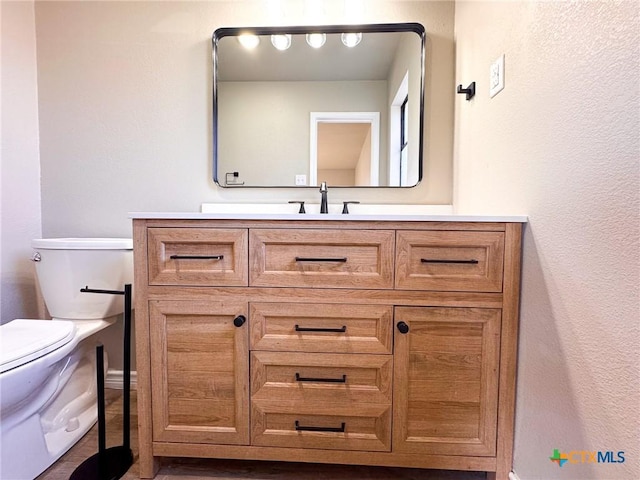 bathroom with vanity and toilet