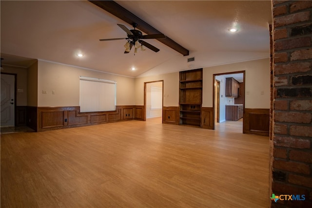 interior space with light hardwood / wood-style floors, ceiling fan, vaulted ceiling with beams, and ornamental molding