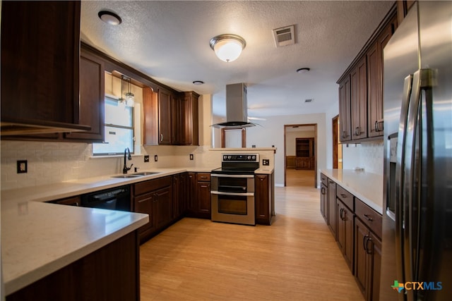 kitchen featuring tasteful backsplash, island exhaust hood, stainless steel appliances, light wood-type flooring, and sink