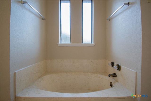 bathroom featuring a tub to relax in