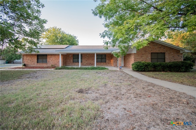 ranch-style home featuring a front yard