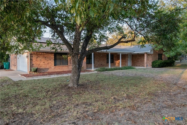 ranch-style home with a garage and a front yard